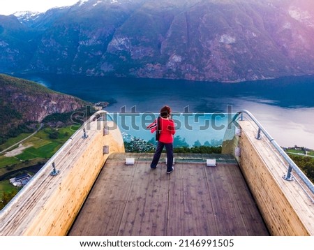 Tourist woman enjoying fjord view Aurlandsfjord landscape from Stegastein viewing point. Norway Scandinavia. National tourist route Aurlandsfjellet. Royalty-Free Stock Photo #2146991505