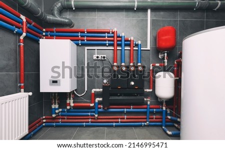 A modern electic boiler room. Equipment for modern heating system as a boiler, heater,pipes, expansion tank and other Royalty-Free Stock Photo #2146995471