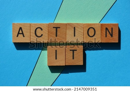 Action It, words in wooden alphabet letters isolated on blue background