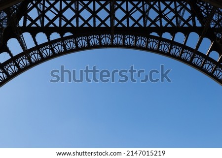 
nice view of part of the Eiffel tower in Paris France. Detail of the tower architecture with a beautiful blue sky in the background and free space for text