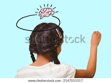 Brain icon with banner with copy space over african american girl writing against blue background. school and education concept
