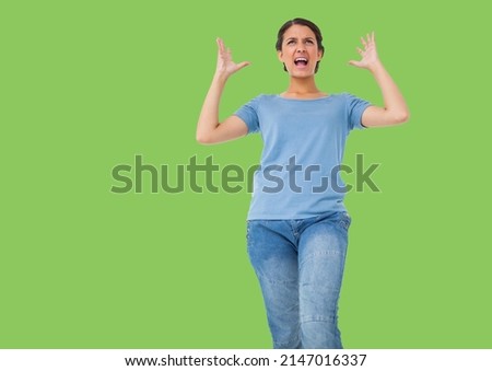 Caucasian woman stressed with hands in the air against copy space on green background. people and emotion concept
