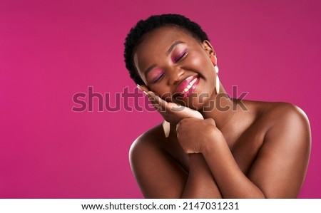 Smile a while and give your face a rest. Studio shot of a beautiful young woman posing against a pink background.