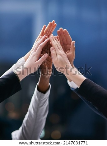 One team working towards one dream. Shot of a group of colleagues giving each other a high five in an office. Royalty-Free Stock Photo #2147031771