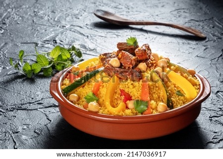 Meat and vegetable couscous in a bowl, typical food from Morocco, a traditional festive Arabic dish with herbs and spices Royalty-Free Stock Photo #2147036917