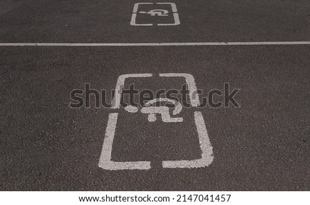 Parking spaces for disabled people, Parking place sign for disabled on grey dark asphalt texture