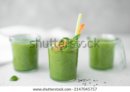 chilled cucumber gazpacho with celery, tomato and basil in a glass, close-up Royalty-Free Stock Photo #2147045757