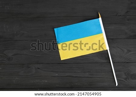 flag of ukraine blue yellow on black wooden background