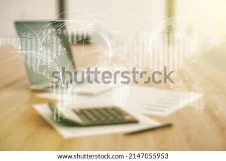 Double exposure of abstract digital world map hologram with connections on blurry calculator with laptop background, research and strategy concept