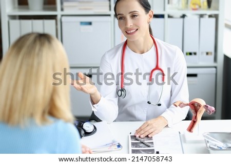 Gynecologist doctor consults woman in clinic. Diseases of female reproductive system and uterus concept Royalty-Free Stock Photo #2147058743