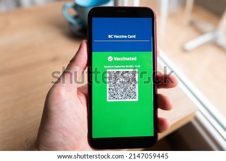 close up of view hands man holding smartphone display on app mobile vaccinated COVID-19 or coronavirus certificate, immunity vaccine passport, new normal travel of tourist concept.
