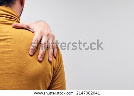 Adult caucasian man with shoulder pain.