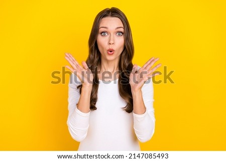 Photo of shocked crazy lady raise palms omg face reaction wear white shirt isolated yellow color background