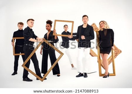 studio portrait of Beautiful young diverse group of friends isolated on white background in the frame for a picture, goofy face, good mood