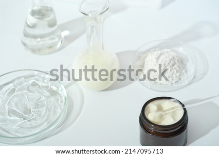 laboratory dishes and glassware on a lab table. fermentation, fermented beauty skin care. container with cream or solution or serum for anti age treatment, powder cosmetic ingredient Royalty-Free Stock Photo #2147095713