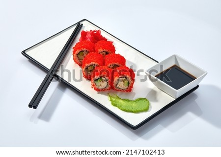 California or Philadelphia sushi rolls set served on a white tray over white background. Japanese cuisine concept, traditional recipe.