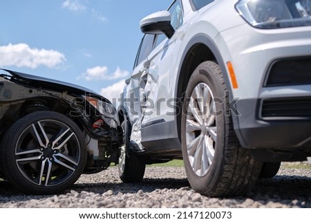Cars crashed heavily in road accident after collision on city street. Road safety and insurance concept Royalty-Free Stock Photo #2147120073
