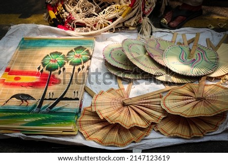 Colorful Hand Fan, Pakha, Pankha, Air Blower or Bamboo Made Handicraft Fan with Handle Sold in Pahela Baishakh - Bangla New Year Royalty-Free Stock Photo #2147123619