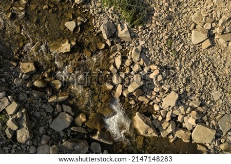 Aerial view of rocky terrain with creek. Drone photography Royalty-Free Stock Photo #2147148283