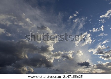 White stormy clouds on blue sky background up view