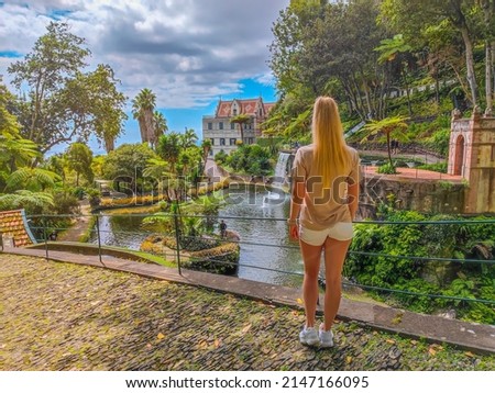 Photo of a girl standing in front of Monte Palace Tropical Gardens in Madeira, Funchal. Botanical park on the mountain in Funchal city Royalty-Free Stock Photo #2147166095
