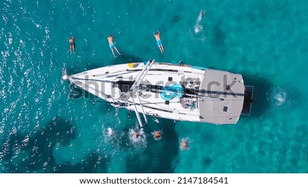 Top view of young friends jumping from sailboat. Yachting. Sail boat party day. Summer luxury boat trip Royalty-Free Stock Photo #2147184541