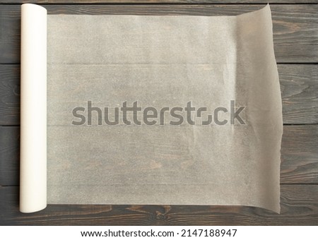 Baking paper on wooden kitchen table for menu or recipes, top view Royalty-Free Stock Photo #2147188947