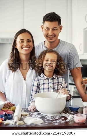 A bond everyone strives for. Portrait of an adorable little girl baking with her parents at home. Royalty-Free Stock Photo #2147198807
