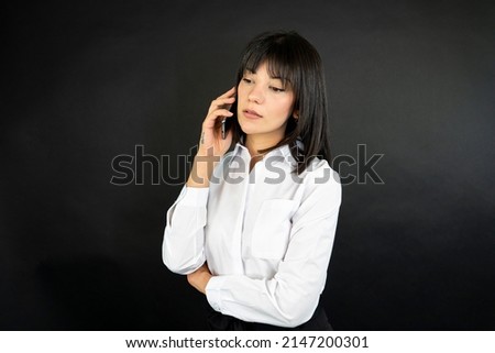 Happy businesswoman using mobile. Cropped image of happy girl using smartphone device 
