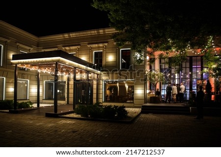 Night view of a restaurant with lots of lights. Royalty-Free Stock Photo #2147212537