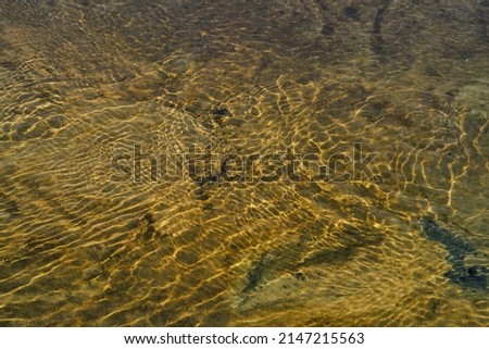 river water closeup sand reflection texture wilderness expanse brown yellow orange