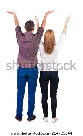 Back view couple  looking at wall and Holds  hand up. Rear view people. Isolated over white background. 