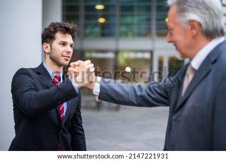 Successful business people joining hands with his boss