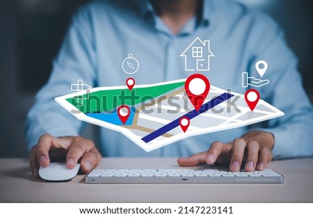 Businessman hand holding virtual world and model map with location point , GPS app, icon Travel maps and find places in the online system, all screen graphics are generated,Searching for travel goals.