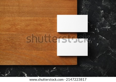Blank business cards on wooden board background. Mockup for ID. Template for graphic designers portfolios. Flat lay.