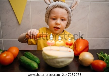 vegetarian cake with candles birthday vegetables baby in rabbit ears. High quality photo