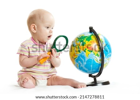 girl on a white background at the table with a globe and notebooks