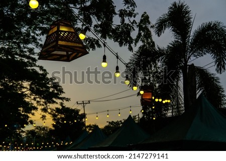 Decorative lights adorn Ramadan celebrations at sunset. Royalty-Free Stock Photo #2147279141