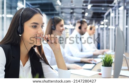 Portrait of call center worker accompanied by his team. Smiling customer support operator at work Royalty-Free Stock Photo #2147280427
