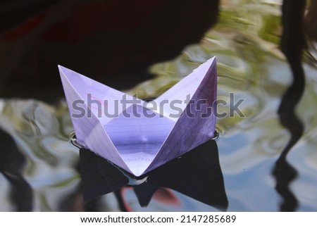 boat made of paper sails on water