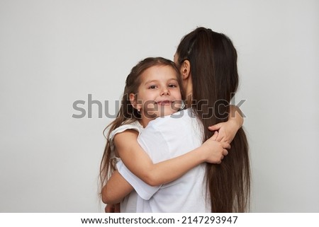Happy woman and child girl 5-6 years old having fun. Young mother with little daughter portrait on white background with copy space. Mother's Day love family concept