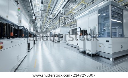 Wide shot of Bright Advanced Semiconductor Production Fab Cleanroom with Working Overhead Wafer Transfer System  Royalty-Free Stock Photo #2147295307