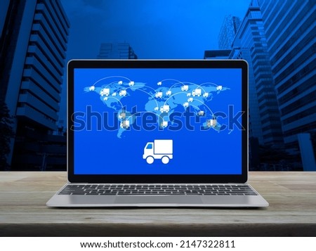 Delivery truck icon with connection line and world map on laptop computer screen on table over city tower, Business transportation online concept, Elements of this image furnished by NASA