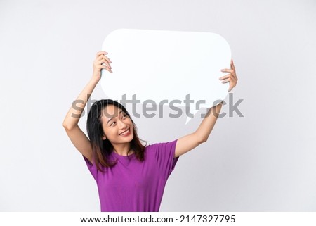Young Vietnamese woman isolated on white background holding an empty speech bubble Royalty-Free Stock Photo #2147327795