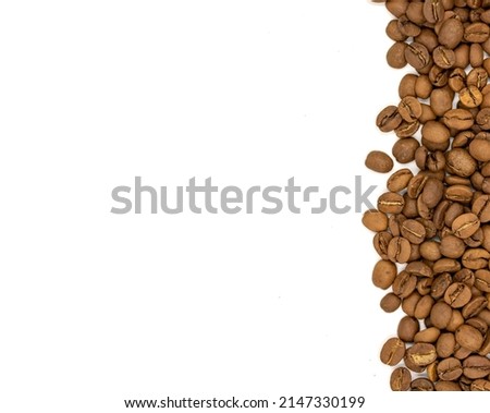 Coffee beans isolated on a white background. One side is full of coffee, the other side is left blank for writing. Close-up. Copy space. Empty space for text. Top view
