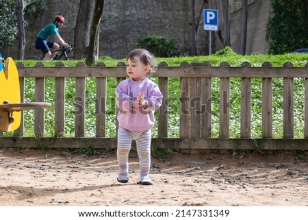 little baby playing in the park on a sunny day Royalty-Free Stock Photo #2147331349