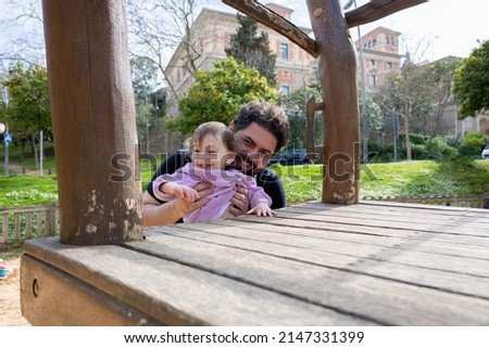 father playing in the park with his little baby happy looking at camera Royalty-Free Stock Photo #2147331399