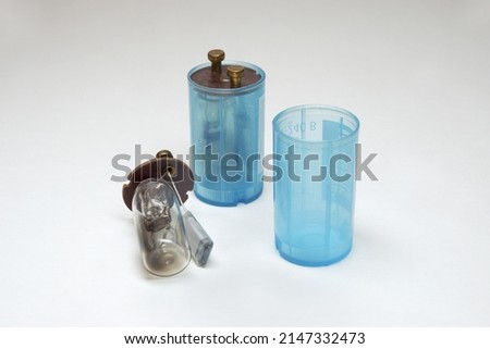fluorescent lamp starters, showing internals, glow discharge tube (burned glass flat bulb with gas), capacitor  Royalty-Free Stock Photo #2147332473