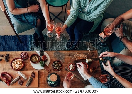 top view of table diner with tapas food - friends people eating and grabbing appetizer sitting around together Royalty-Free Stock Photo #2147338089