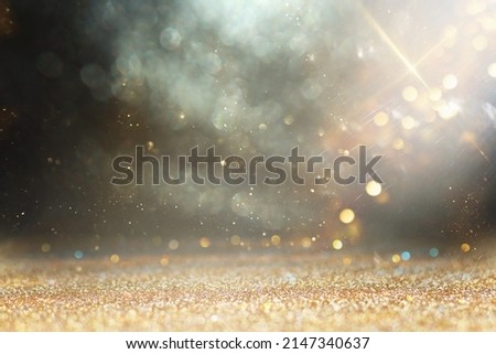 background of abstract gold, black and silver glitter lights. defocused